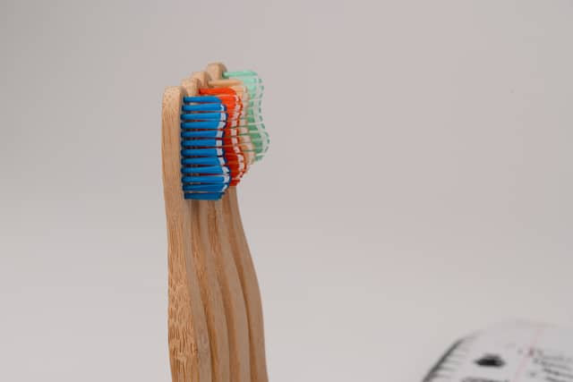 4 toothbrush heads are photographed standing, slightly fanned out, on a white background