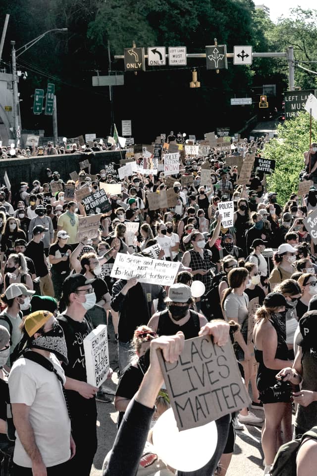 A group of Black Lives Matter protestors crowd a city street