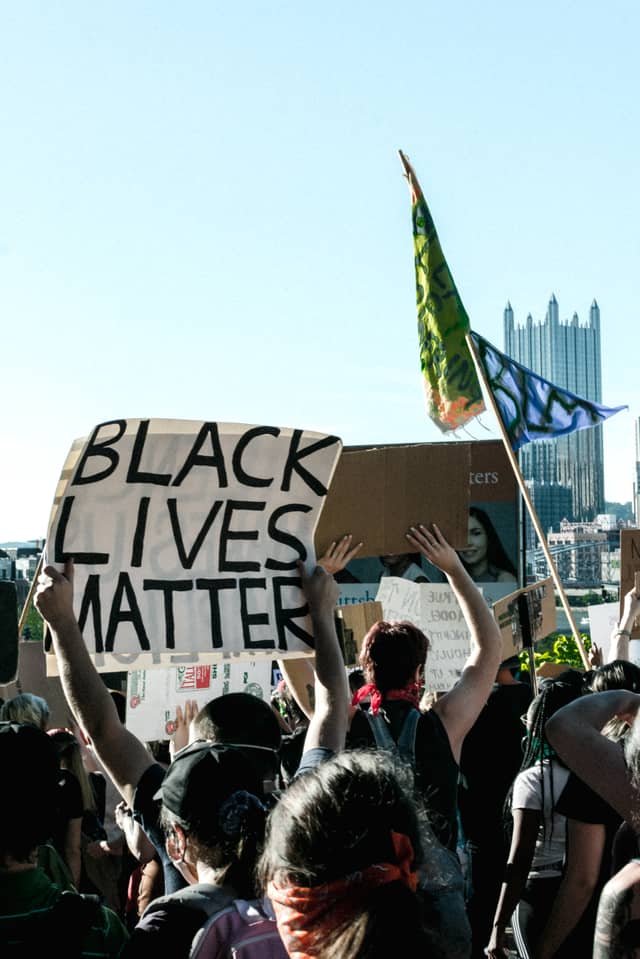 Someone holds a Black Lives Matter sign in the middle of a protest