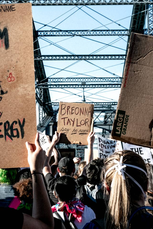 Someone holds a protest sign that says 'Breonna Taylor, say her name' during a Pittsburgh Black Lives Matter protest