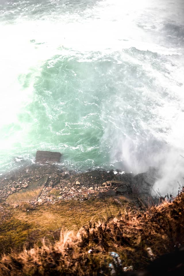 swirling water is shown crashing along a rock bed