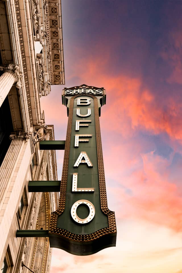 A marquee sign that says 'Sheas Buffalo' is shown from directly below it looking up