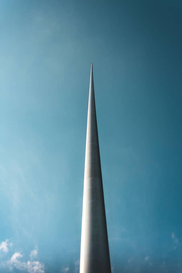 A tall metal pole is shown from the bottom up, as if it goes up forever